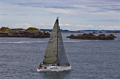 Nicolas Loday and Jean Claude Nicoleau's Grand Soleil 43 Codiam, racing past the Scilly Isles, during the Rolex Fastnet Race 2011. Photo copyright Rolex and Carlo Borlenghi.