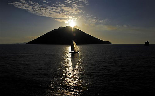 Andres Soriano’s Mills 68 Alegre (GBR) approaching Stromboli with nearby Strombolicchio seen on the far right, during the Rolex Middle Sea Race 2011. Photo copyright Kurt Arrigo, Rolex.