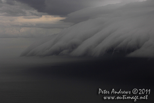 Seen from Bulli Lookout near Wollongong, a storm front cloud band rolls up the New South Wales over the Tasman Sea, during the first evening at sea for the 2011 Rolex Sydney Hobart Fleet. Photo Copyright Peter Andrews, Outimage Australia.