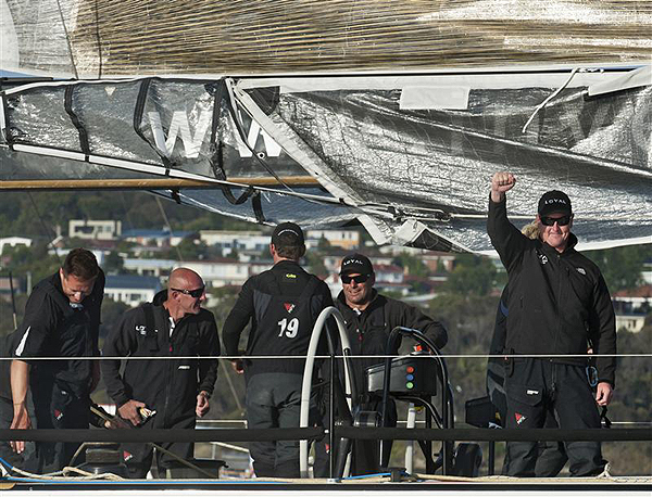A jubiliant Anthony Bell raises his hand on Investec Loyal, after crossing the Hobart ahead of Bob Oatley's Wild Oats XI. Photo copyright Kurt Arrigo, Rolex.