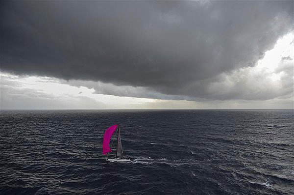The pink spinnaker of Gérard Logel's Arobas (FRA) is contrasted by dark skies as she approaches the Aeolian Islands, during leg two of the Rolex Volcano Race 2012. Photo copyright Kurt Arrigo for Rolex.
