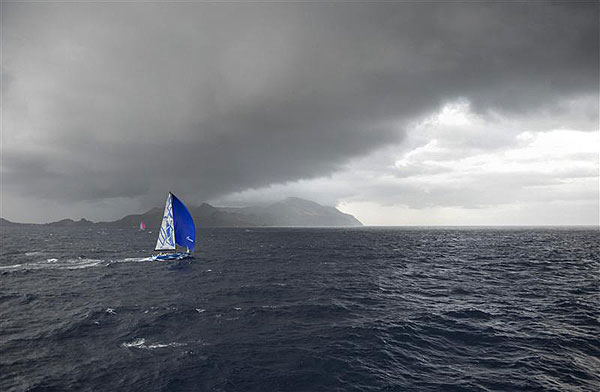 Vladimir Liubonirov's Bronenosec (RUS) sails towards the storm, with Gérard Logel's Arobas (FRA) in the distant background, during leg two of the Rolex Volcano Race 2012. Photo copyright Kurt Arrigo for Rolex.