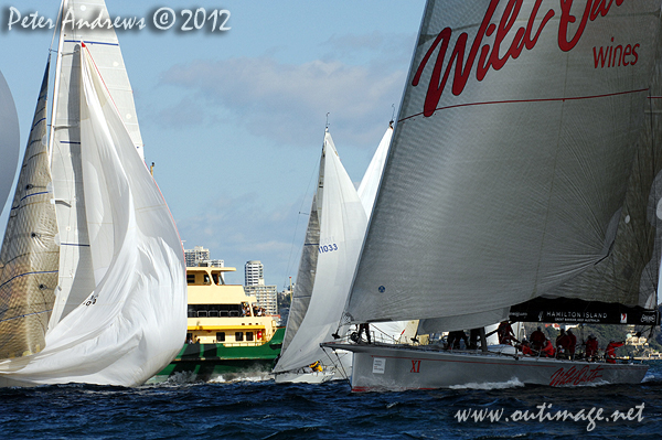 A Manly ferry splits the fleet during the start of the Audi Sydney Gold Coast 2012. Photo copyright Peter Andrews, Outimage Australia.