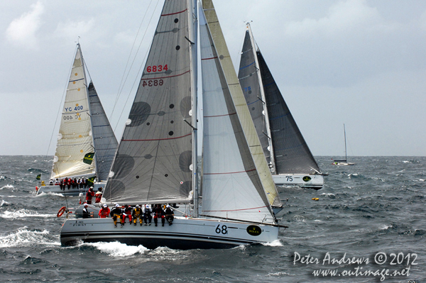 Three Beneteau First 40s', Jonathan Stone's Breakthtough (68) Chris Tucker's Halcyon (75) and previous overall winner, Andrew Sales' Two True (YC400), outside the heads of Sydney Harbour after the start of the 2012 Sydney Hobart Yacht Race. Photo copyright Peter Andrews, Outimage Australia.